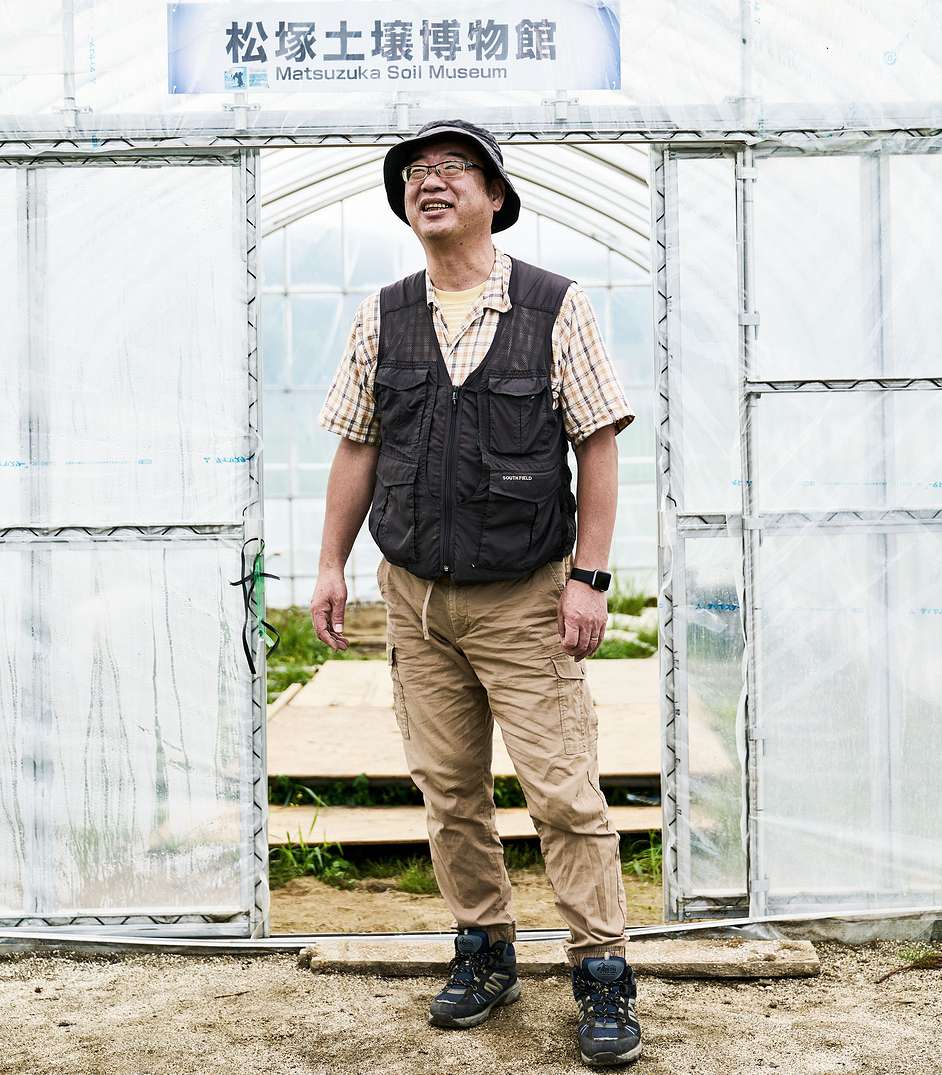 A farmer standing outside a greenhouse in Fukushima