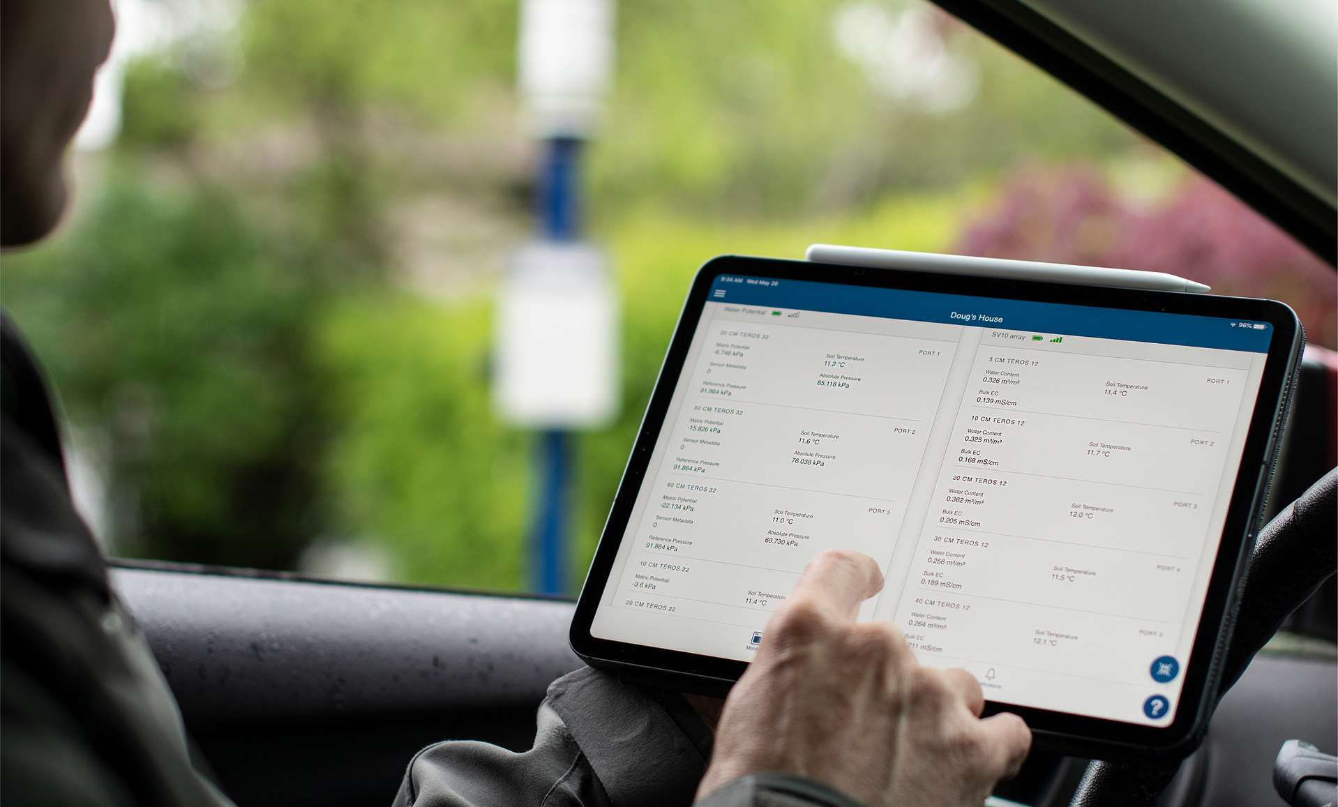 Person sitting in a car with a tablet in their hands accessing the ZENTRA Cloud platform