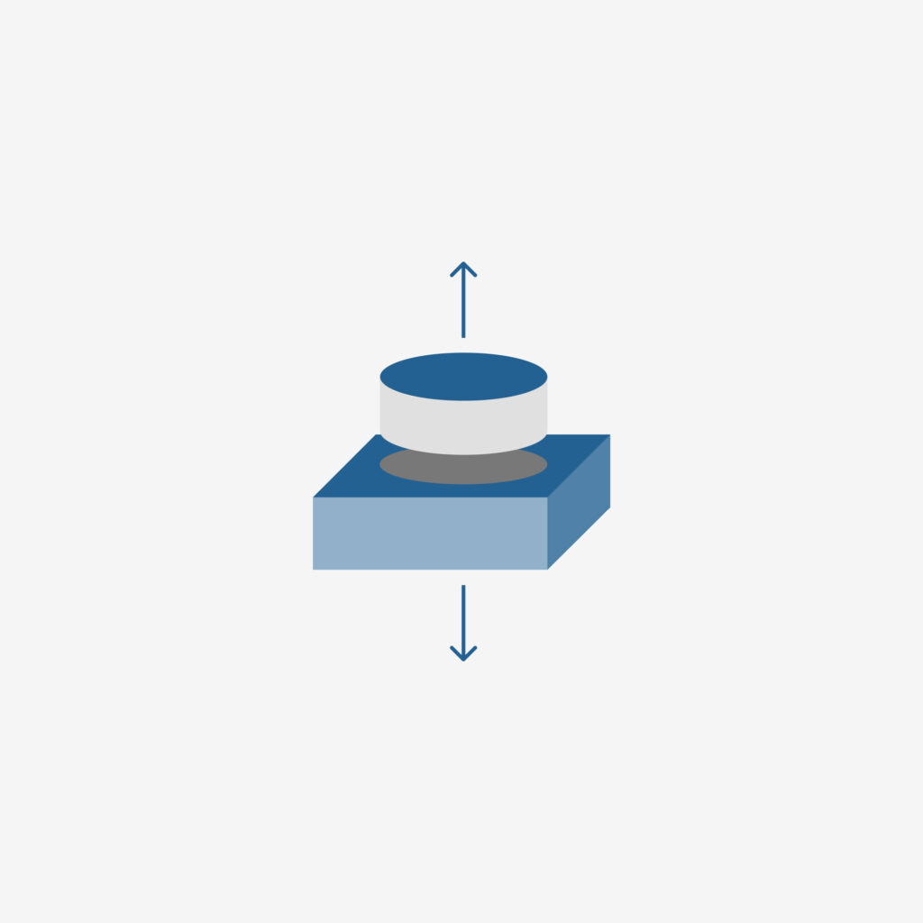 An illustration of a slice of a cylinder atop a slice of a cube with arrows above and below