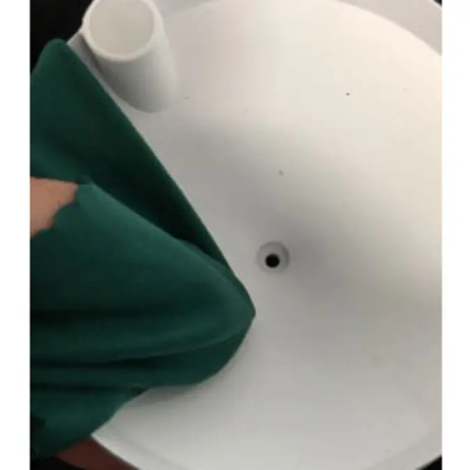A photograph of someone using a clean, damp cloth to wipe out the funnel.