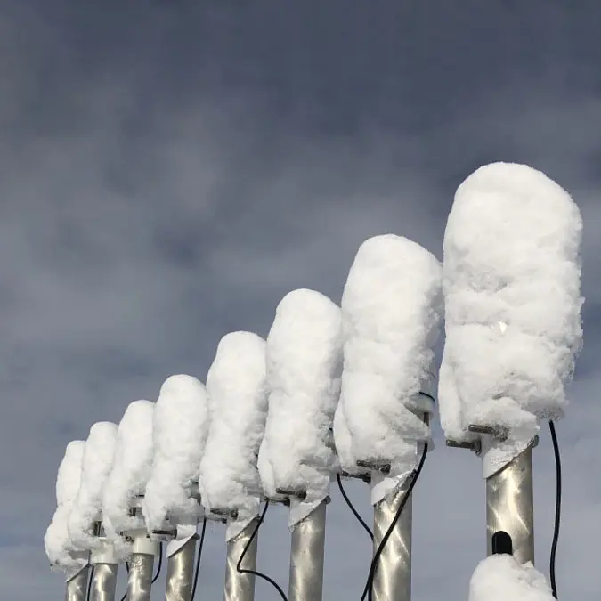 A photograph of METER’s rooftop testbed with ATMOS 41s covered in snow